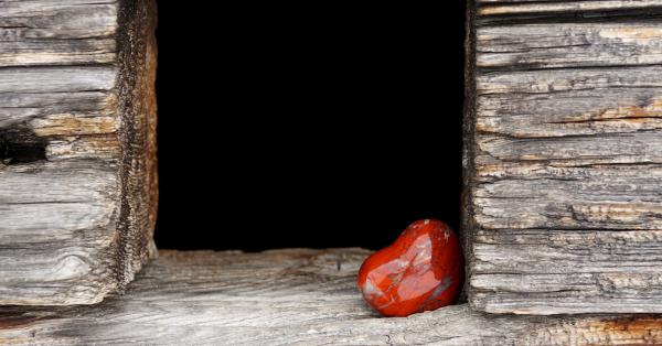 Houten frame met rechtonderin een rood, stenen hartje