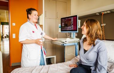 Foto van een verpleegkundige aan bed